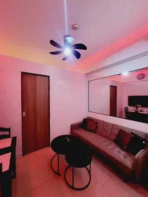 a living room with a couch and a ceiling fan at Mavic Staycation in Manila