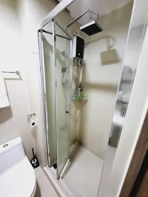 a shower in a bathroom with a glass shower stall at Mavic Staycation in Manila