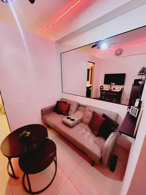 a living room with a couch and a table at Mavic Staycation in Manila