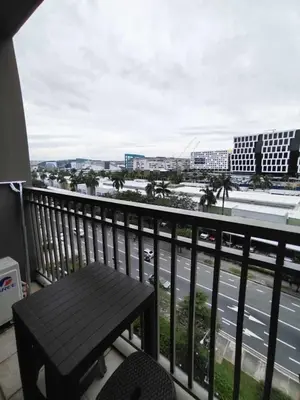a balcony with a bench and a view of a street at Shore 1 Residences - 1 Bedroom with Balcony in Manila