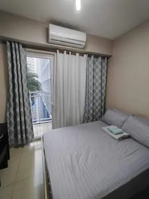 a small bedroom with a bed and a window at Shore Residences - 1 Bedroom with Balcony in Manila