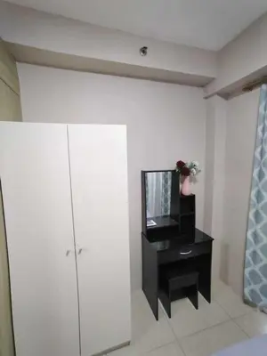 a living room with a tv and a black cabinet at Shore Residences - 1 Bedroom with Balcony in Manila