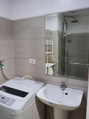 a bathroom with a sink and a mirror at Shore Residences - 1 Bedroom with Balcony in Manila