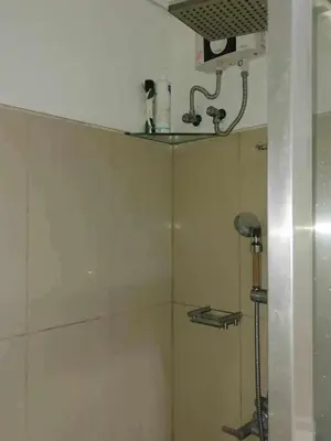 a bathroom with a shower with a shower head at spacious 1 br fully furnished condo in Manila