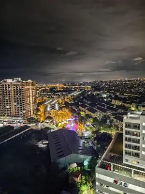 a view of a city at night at VM Staycation Grace Residence Taguig in Manila