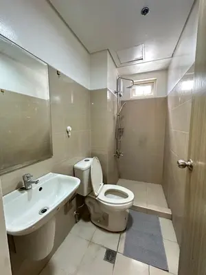a bathroom with a toilet and a sink at 2br shore residences staycation in Manila