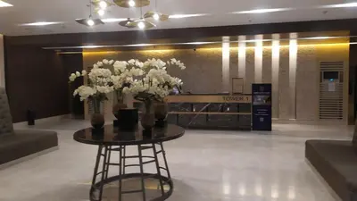 a table with flowers on it in a lobby at Casa Laelia in Manila