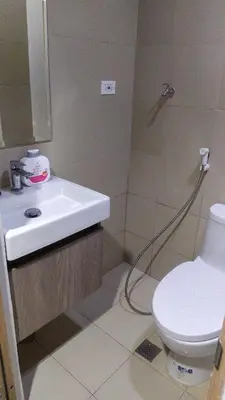 a bathroom with a sink and a shower with a toilet at Casa Laelia in Manila