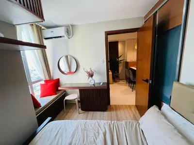 a bedroom with a bed and a desk and a mirror at HIGHLY RECOMMENDED La Nooq MNL - Cozy 1BR Skyline view in Mandaluyong in Manila