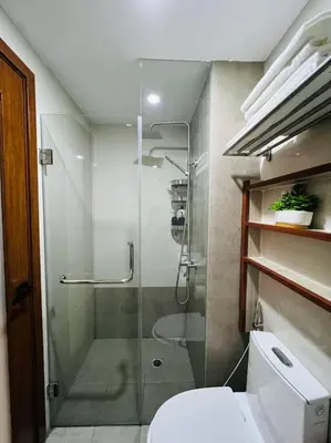 a bathroom with a glass shower and a toilet at HIGHLY RECOMMENDED La Nooq MNL - Cozy 1BR Skyline view in Mandaluyong in Manila