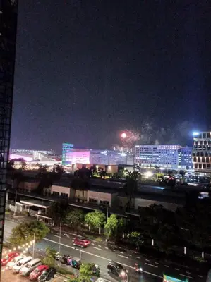a city at night with cars parked on a street at 1 Bedroom with Balcony Near MOA in Manila