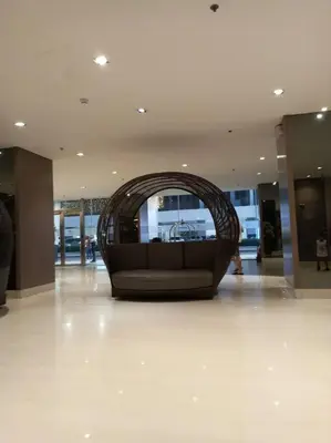 a couch in the middle of a lobby at 1 Bedroom with Balcony Near MOA in Manila