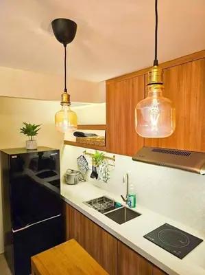 a kitchen with two pendant lights and a counter top at Instragamable2BR near Bridgetown in Manila