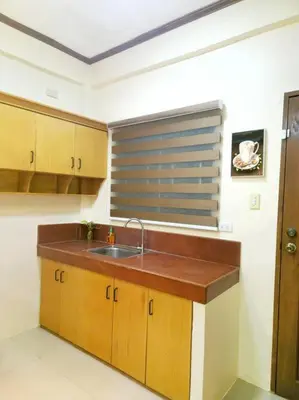 a kitchen with a sink and a window at Spacious Apartment near Evia Daang Hari in Manila
