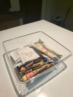 a plastic container filled with toothbrushes and toothpaste at Spacious Apartment near Evia Daang Hari in Manila