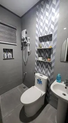 a bathroom with a toilet and a sink at Spacious Apartment near Evia Daang Hari in Manila