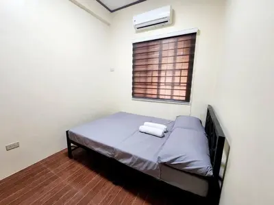 a small bedroom with a bed with a window at Spacious Apartment near Evia Daang Hari in Manila