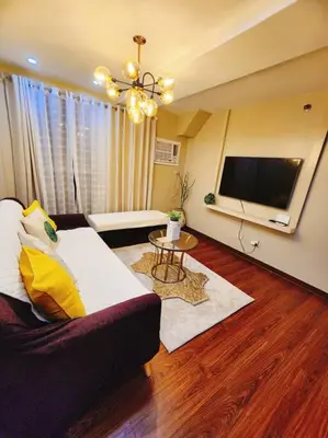 a living room with a couch and a flat screen tv at 2BR 90sqm Furnished Condo Shaw Blvd, Mandaluyong in Manila