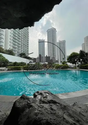 a swimming pool in the middle of a city at MetroNest Dettifoss in Manila