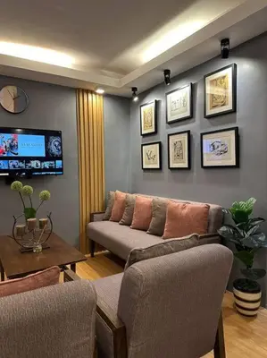 a living room with a couch and a table at H&D Suites-Memories are personal in Imus