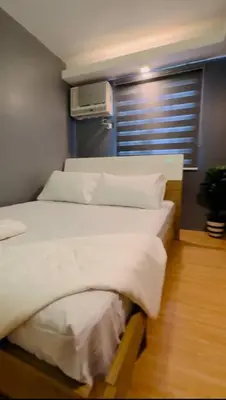 two twin beds in a room with a window at H&D Suites-Memories are personal in Imus