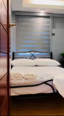 a bedroom with two beds and a window at H&D Suites-Memories are personal in Imus