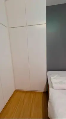 a white room with a bed and a white wall at H&D Suites-Memories are personal in Imus