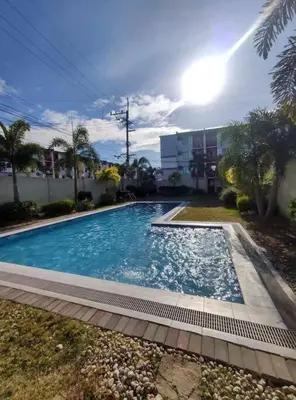 a large swimming pool in front of a building at H&D Suites-Memories are personal in Imus