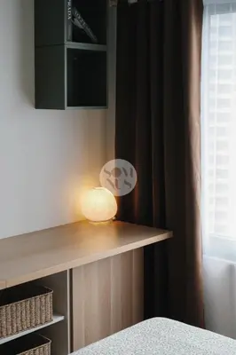 a lamp sitting on a shelf in a bedroom at Somnus Suites at Air Residences in Manila