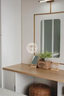 a dressing table with a mirror and a plant on it at Somnus Suites at Air Residences in Manila