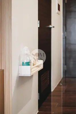 a door with a box of detergent on a wall at Somnus Suites at Air Residences in Manila