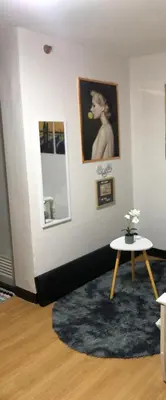 a living room with a table and a picture on a wall at Your Home Away From Home in Imus