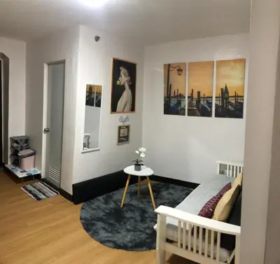a room with a bed and some pictures on the wall at Your Home Away From Home in Imus