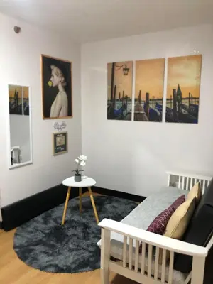 a bedroom with a bed and a table in it at Your Home Away From Home in Imus