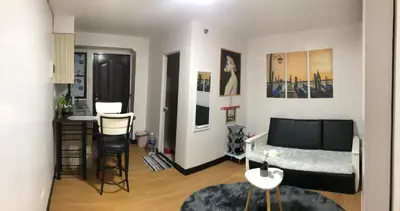 a living room with a couch and a table at Your Home Away From Home in Imus