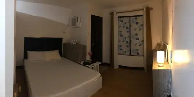 a bedroom with a bed and a door to a room at Your Home Away From Home in Imus