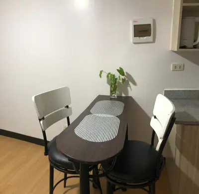 a table with two chairs and a table with a plant on it at Your Home Away From Home in Imus