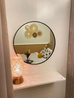 a mirror on a shelf with a bed and a lamp at Aesthetic walking distance to MOA,near NAIA AIRPORT with NETFLIX,MINIVIDEOKE,BOARDGAMES-DUXE2 in Manila