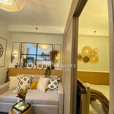 a living room with a couch and a mirror at Aesthetic walking distance to MOA,near NAIA AIRPORT with NETFLIX,MINIVIDEOKE,BOARDGAMES-DUXE2 in Manila