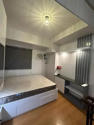 a bedroom with a large bed and a ceiling at Newly Reneuvated Fully Furnished Condo Apartment in the Heart of Mandaluyong in Manila