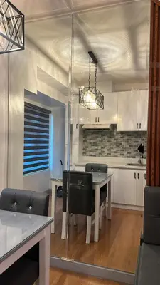 a kitchen with a table and chairs in a room at Newly Reneuvated Fully Furnished Condo Apartment in the Heart of Mandaluyong in Manila