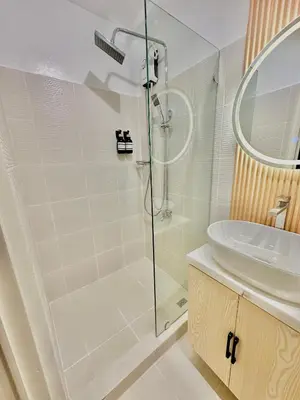 a bathroom with a shower and a sink at Cozy Beit 1125 in Metro Manila in Manila