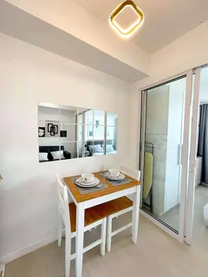 a white dining room table with chairs and a mirror at Azure Urban Resort Parañaque Near Airport and SM Mall in Manila