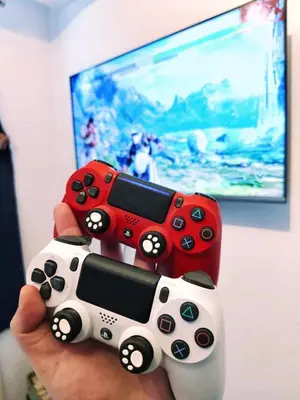 a person holding two video game controllers in front of a tv at Azure Urban Resort Residences Paranaque Near Airport and Mall in Manila