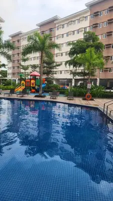 a large swimming pool in front of a building at Empress Suite SMDC Hope Residences CONDOTEL with UNLIWIFI in Trece Martires