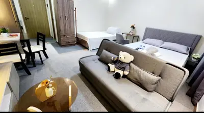 a teddy bear sitting on a couch in a living room at Empress Suite SMDC Hope Residences CONDOTEL with UNLIWIFI in Trece Martires