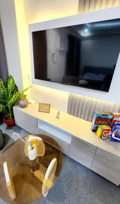 a living room with a table and a tv on a wall at Empress Suite SMDC Hope Residences CONDOTEL with UNLIWIFI in Trece Martires