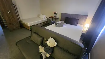 a stuffed teddy bear sitting on a couch in a room at Empress Suite SMDC Hope Residences CONDOTEL with UNLIWIFI in Trece Martires