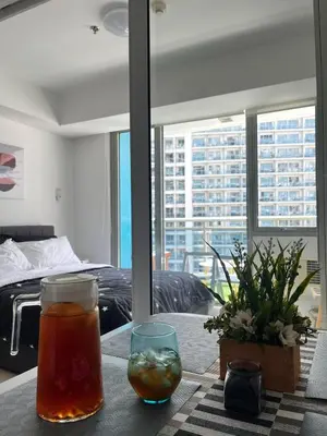 a table with a drink and a glass on a table at Azure Urban Residences by Lyn in Manila