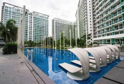 a large swimming pool in front of some buildings at Azure Urban Residences by Lyn in Manila